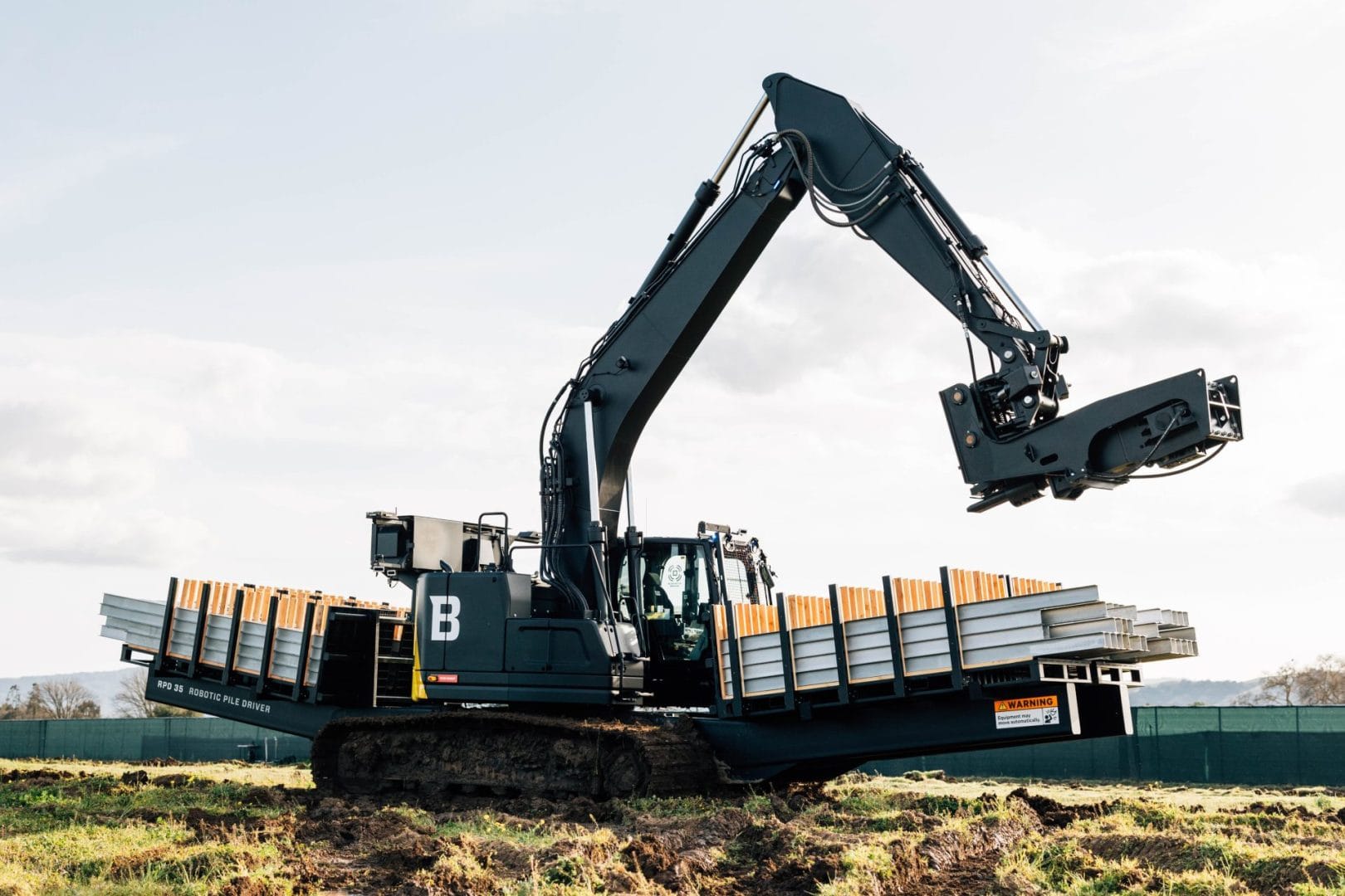 Built Robotics RPD 35 autonomous pile driver installing a solar pile on site