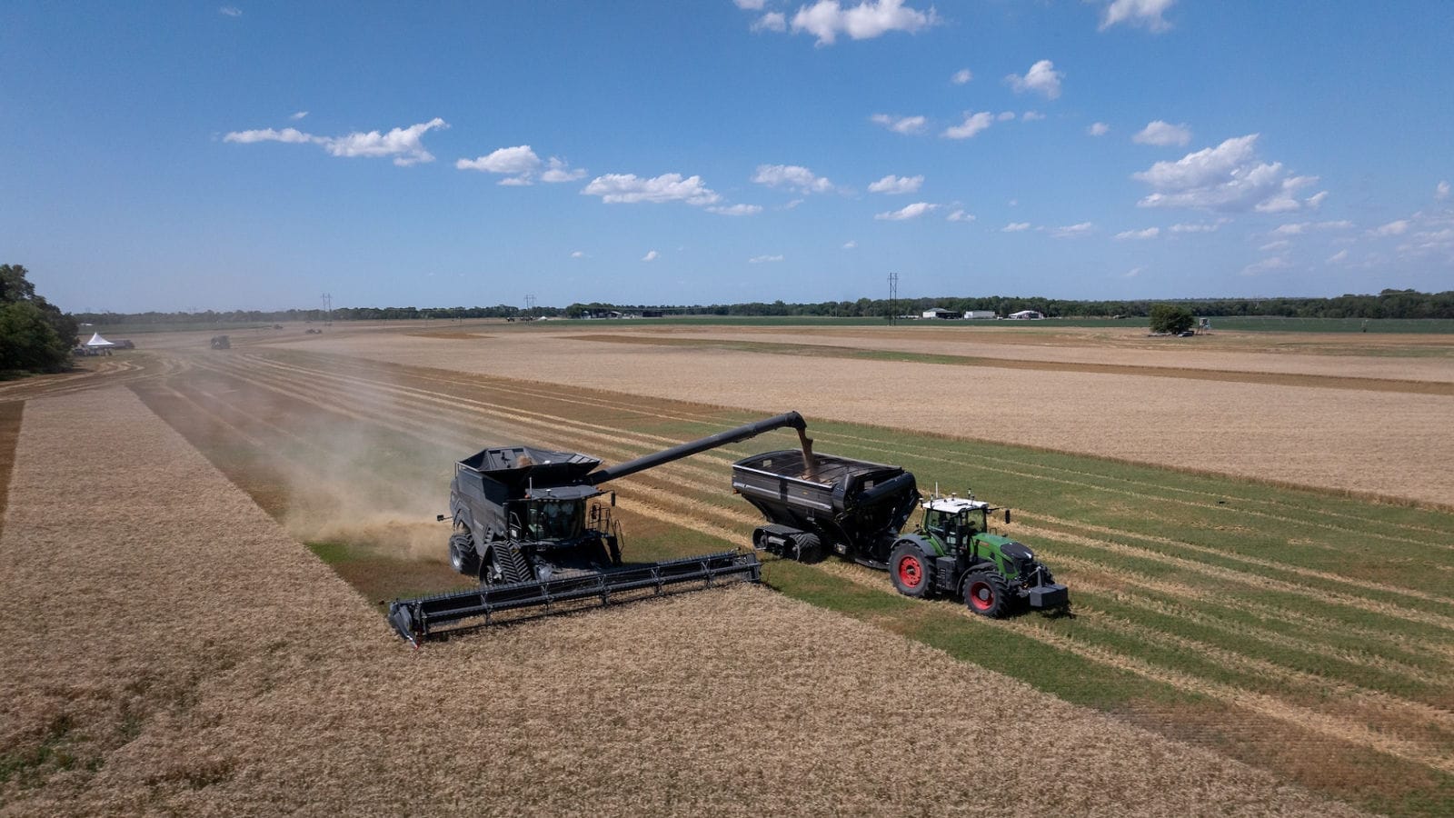 Aerial view of a Fendt and grain cart running alongside a combine